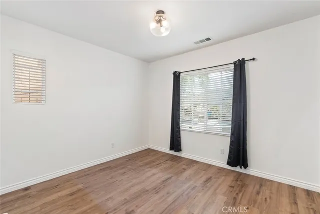a view of a livingroom with a ceiling fan and window