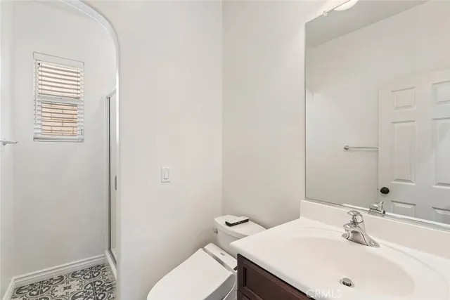 a living room with stainless steel appliances kitchen island granite countertop a sink and a refrigerator