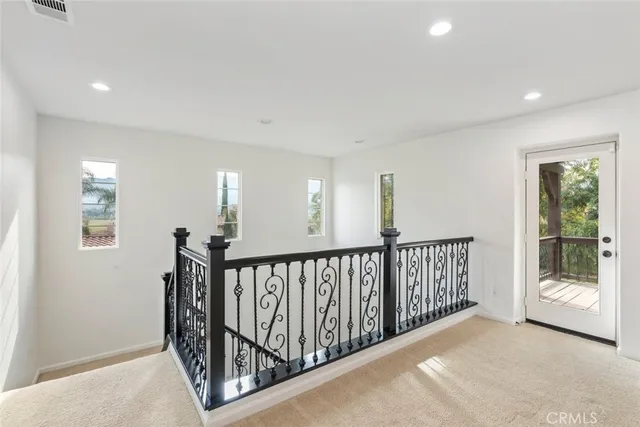 a view of a balcony with floor to ceiling window with wooden fence