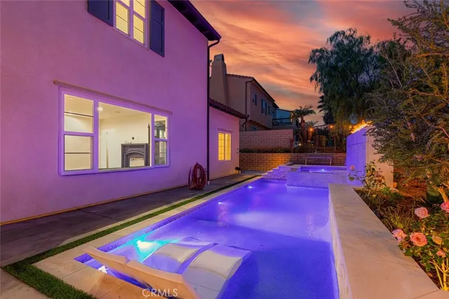 a view of a swimming pool with an outdoor space and seating area