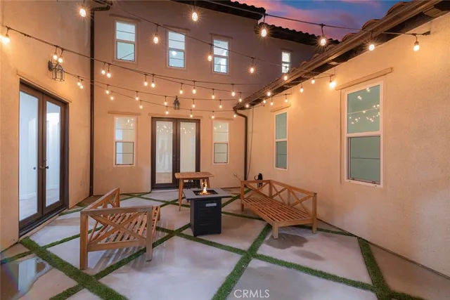 an aerial view of a house with a yard a table and chairs