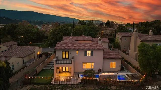an aerial view of residential houses with outdoor space and street view