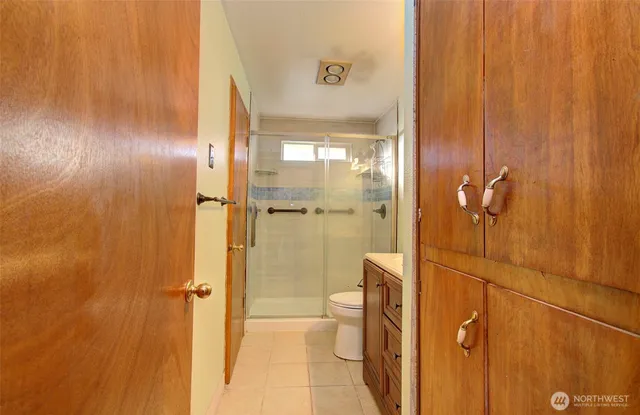 an empty room with closet and windows