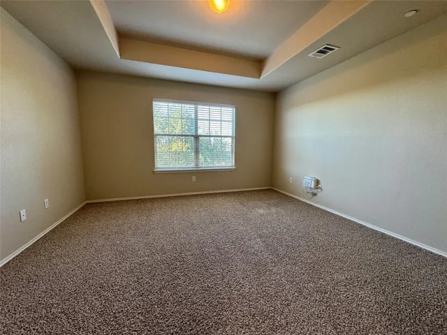 an empty room with a empty space and windows