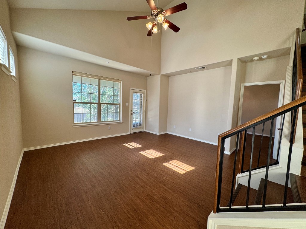 3101 Davis Lane, Unit 8703 Austin, TX 78748 - Photo 3 of 23 a view of an empty room with window wooden floor and a ceiling fan