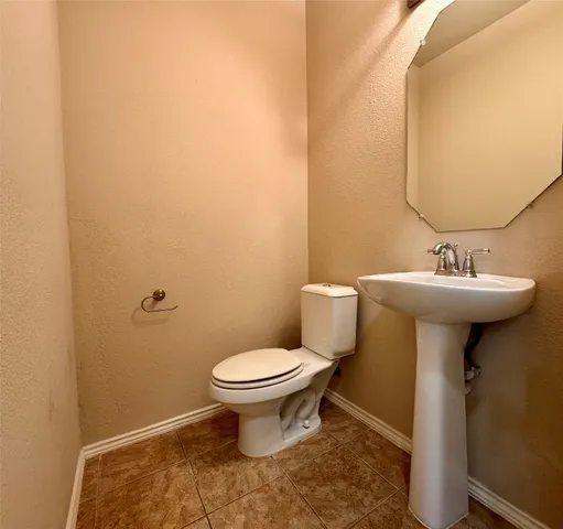 a bathroom with a sink toilet and a mirror