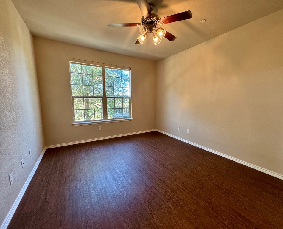 3101 Davis Lane, Unit 8703 Austin, TX 78748 - Photo 9 of 23 wooden floor in an empty room with a window