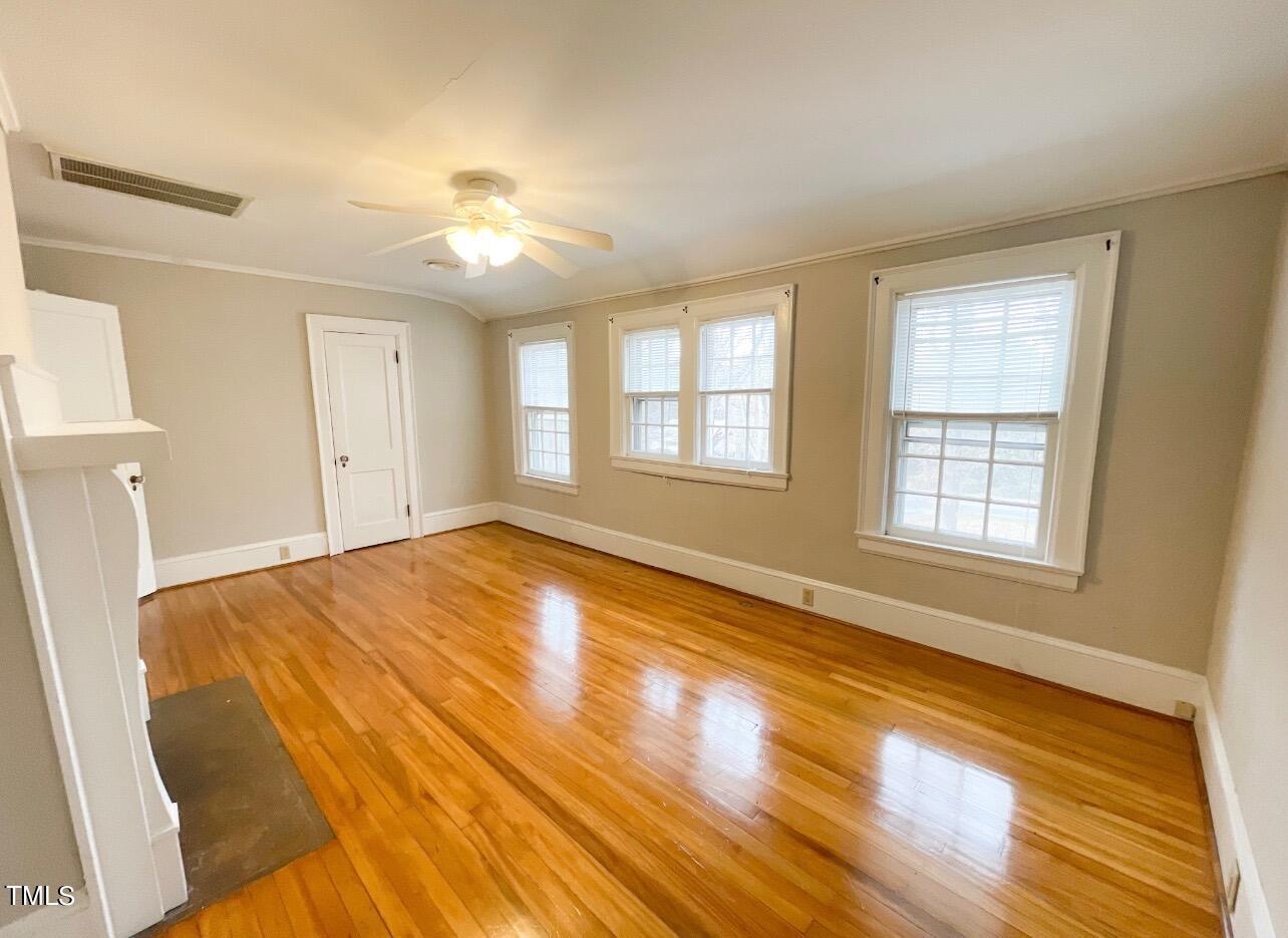 237 Wesleyan Heights Road Roxboro, NC 27573 - Photo 25 of 39 a view of empty room with wooden floor and fan