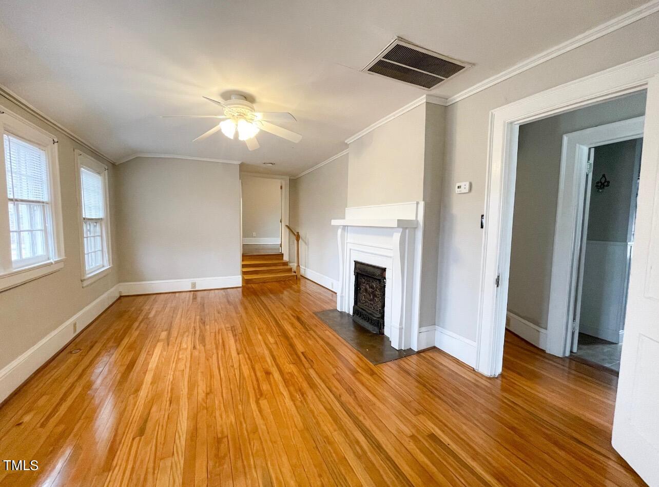 237 Wesleyan Heights Road Roxboro, NC 27573 - Photo 26 of 39 a view of empty room with wooden floor and fireplace