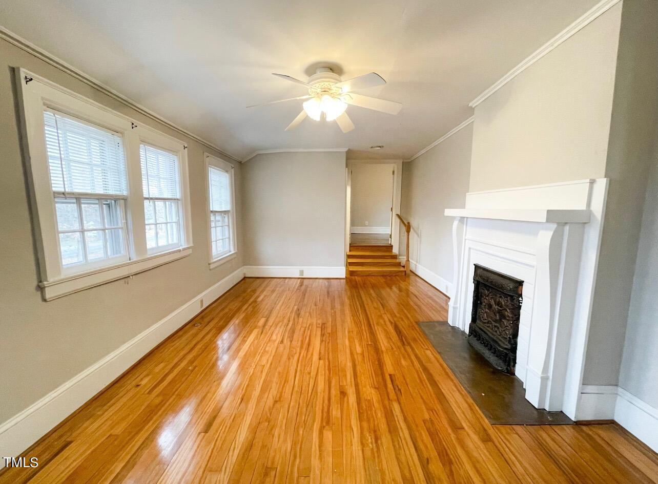 237 Wesleyan Heights Road Roxboro, NC 27573 - Photo 27 of 39 a view of empty room with wooden floor and fireplace
