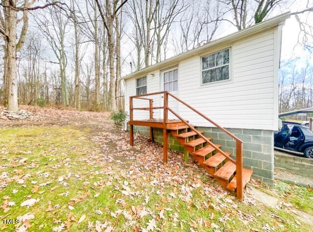 237 Wesleyan Heights Road Roxboro, NC 27573 - Photo 33 of 39 a view of a house with a patio
