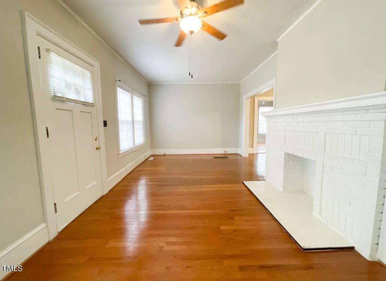 237 Wesleyan Heights Road Roxboro, NC 27573 - Photo 6 of 39 a view of an empty room with wooden floor and a window