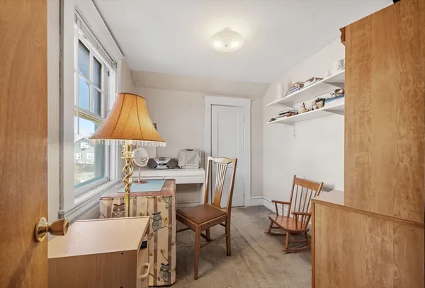 a view of a dining room with furniture and a window