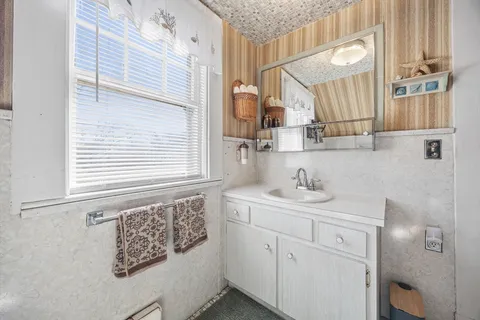 a bathroom with a sink a vanity and a mirror