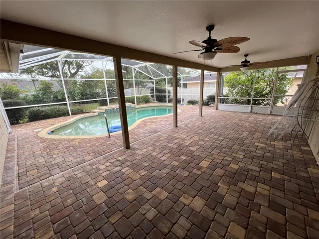 a view of a backyard with a tub and wooden fence