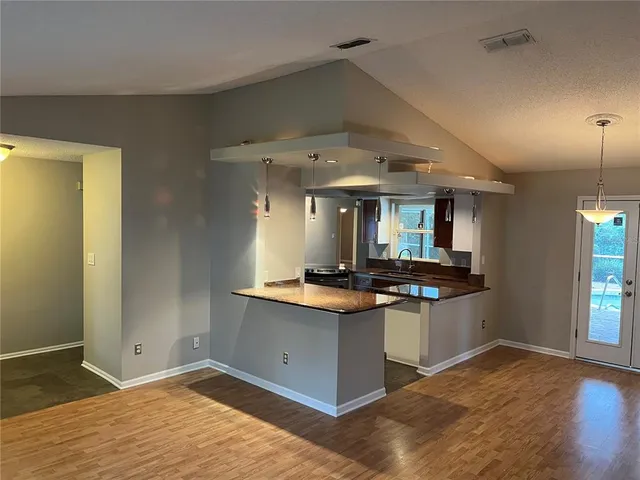 a kitchen with stainless steel appliances granite countertop a stove and a sink