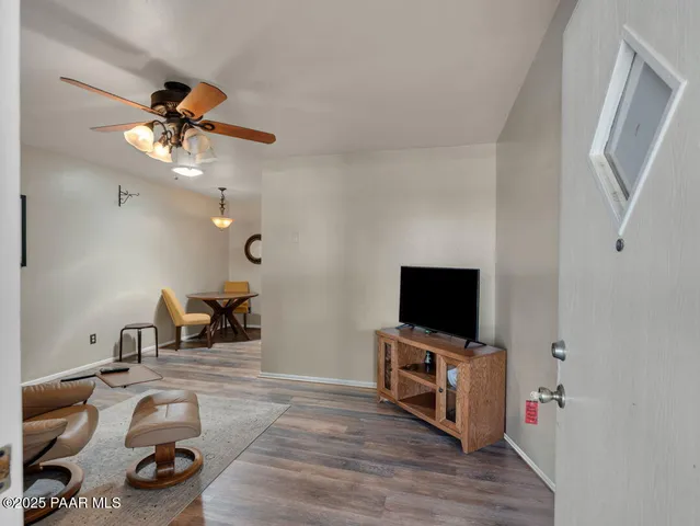 a view of a livingroom with furniture and a flat screen tv