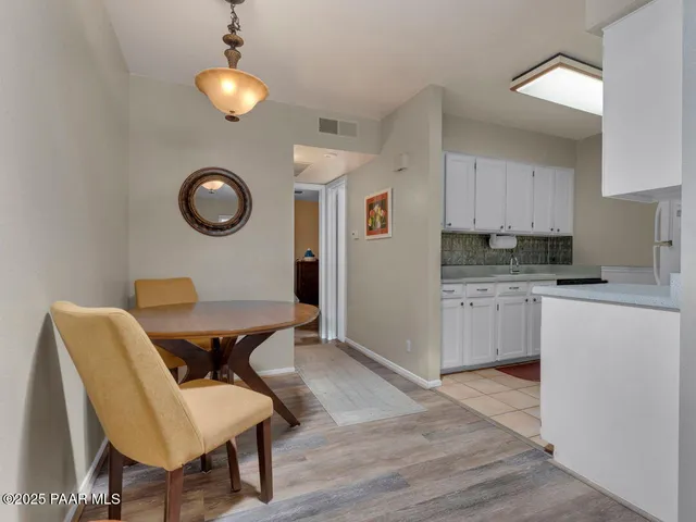 a kitchen with a table chairs and a stove