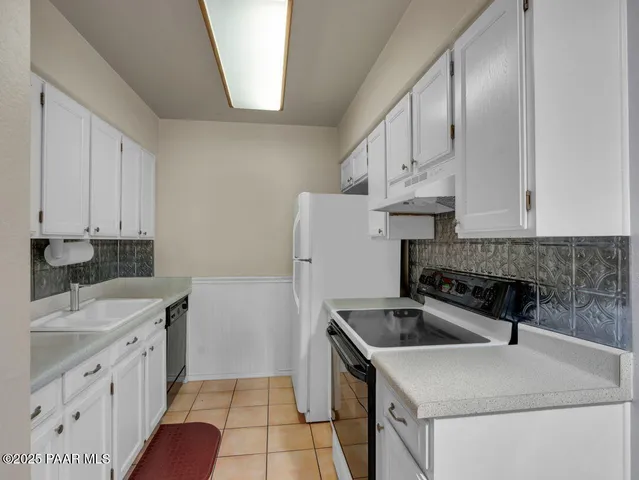 a kitchen that has a sink and a stove