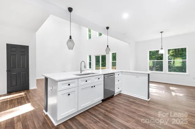 a large white kitchen with a large window