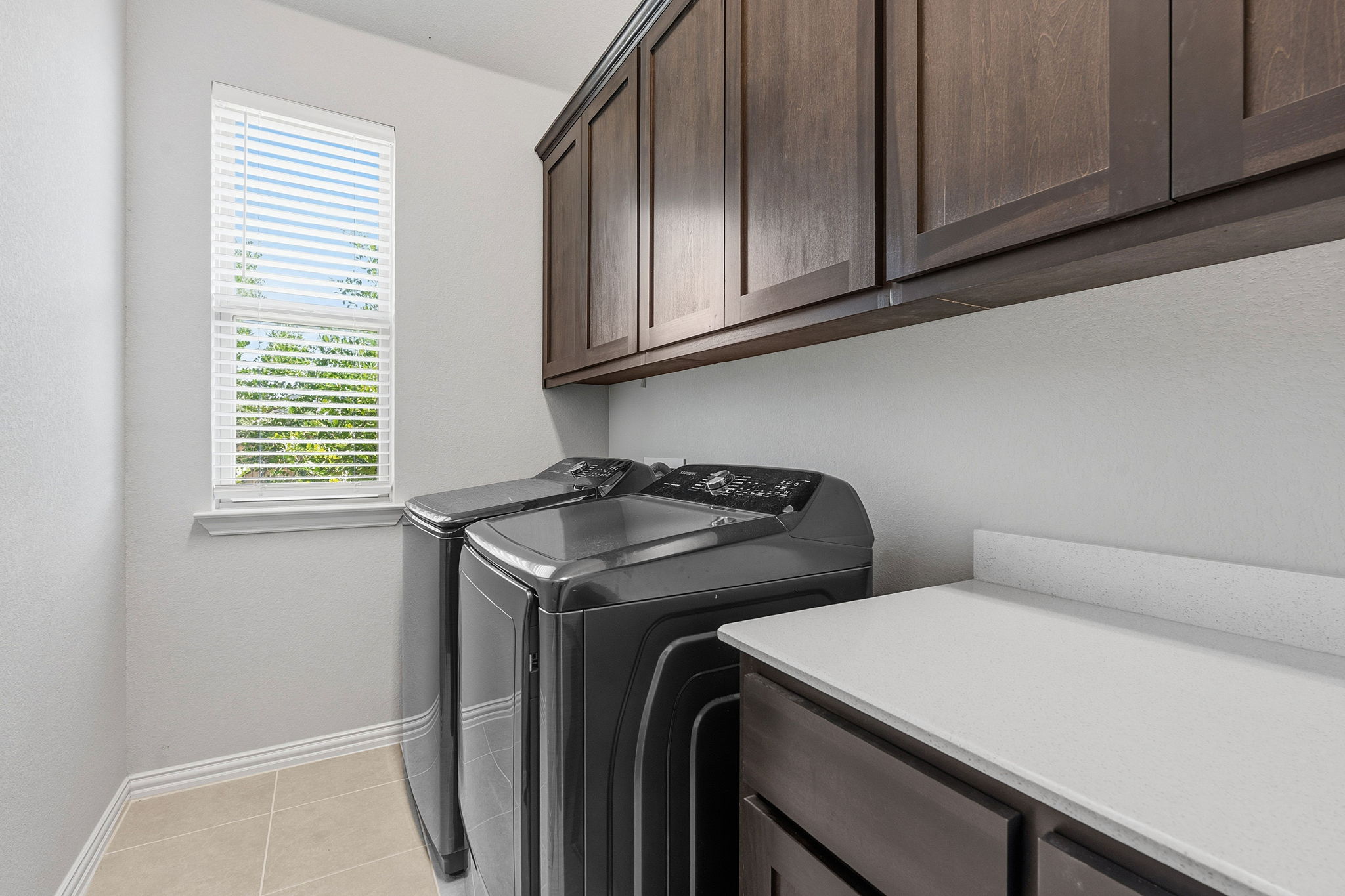 12616 Twisted Root Drive Manchaca, TX 78652 - Photo 27 of 36 Spacious in home laundry with excellent cabinetry storage and a vanity for folding.