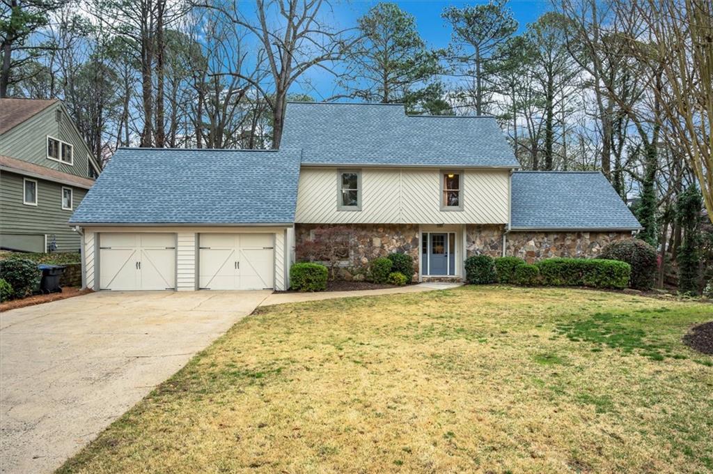 230 Back Tee Court Roswell, GA 30076 - Photo 1 of 1 a front view of a house with a yard and garage