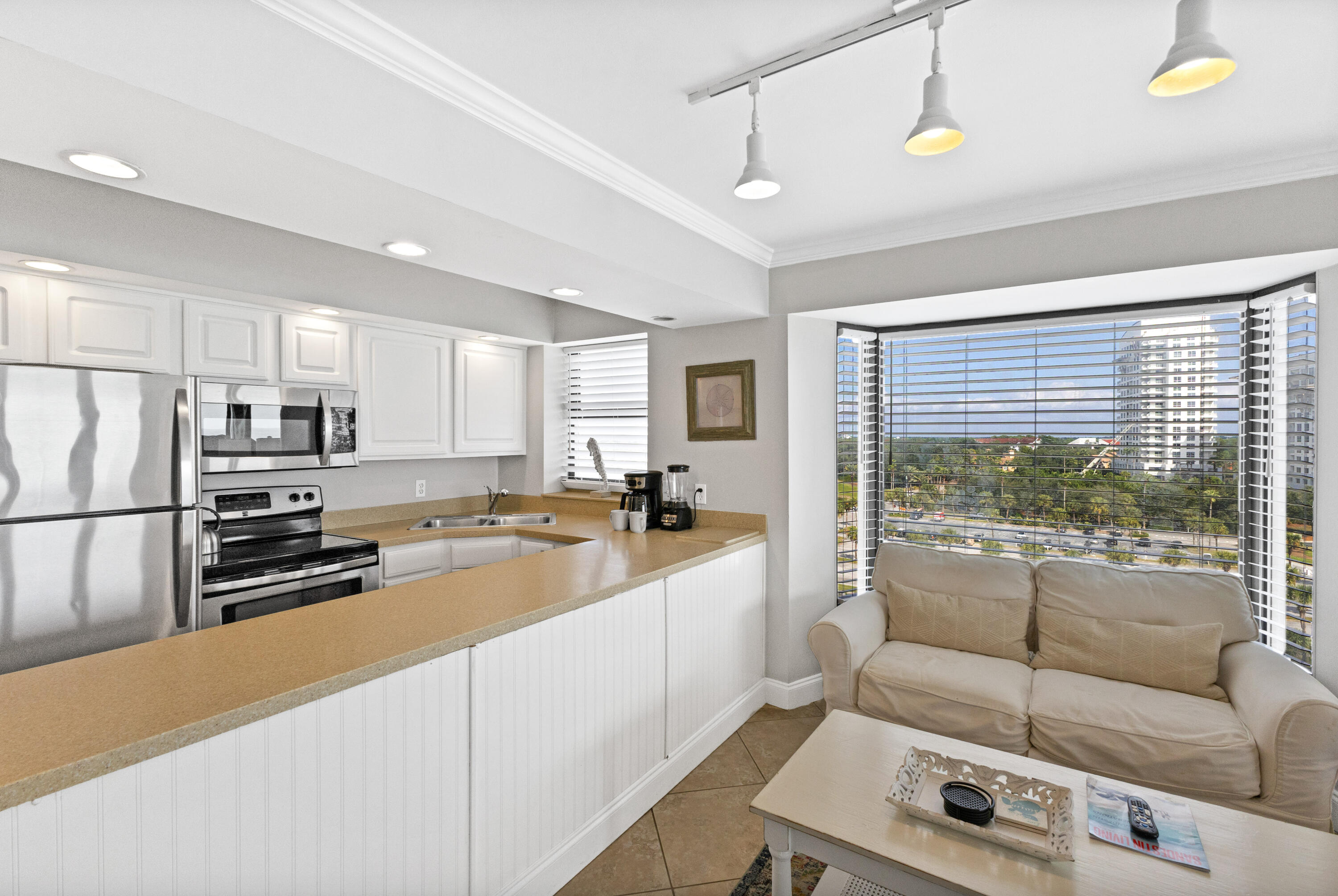 4299 Beachside 2, Unit 4299 Miramar Beach, FL 32550 - Photo 12 of 43 a kitchen with stainless steel appliances a refrigerator a sink and white cabinets
