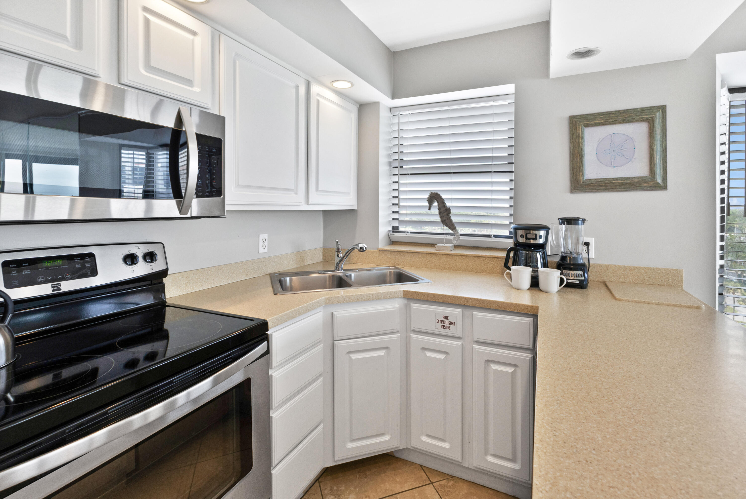 4299 Beachside 2, Unit 4299 Miramar Beach, FL 32550 - Photo 13 of 43 a kitchen with appliances cabinets and a sink