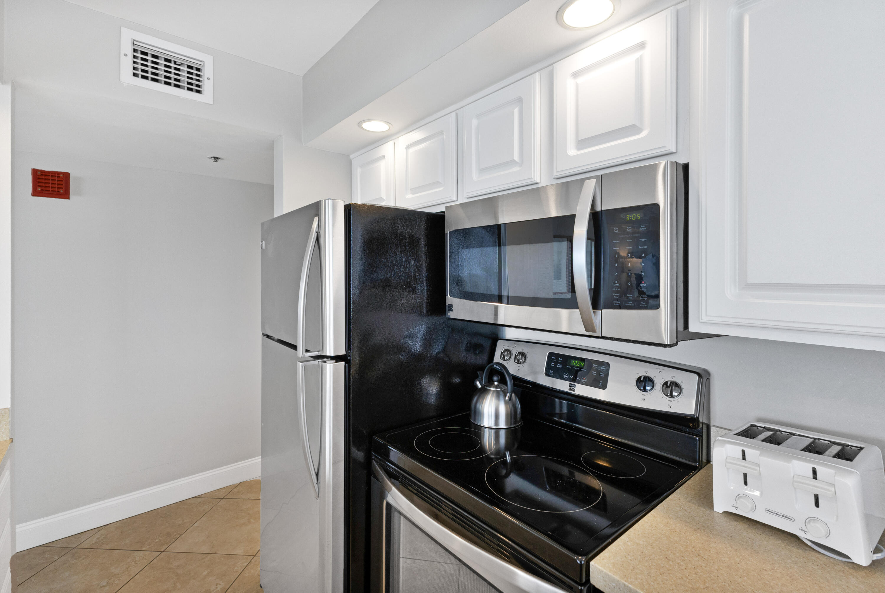 4299 Beachside 2, Unit 4299 Miramar Beach, FL 32550 - Photo 14 of 43 a kitchen with stainless steel appliances granite countertop a stove and a refrigerator