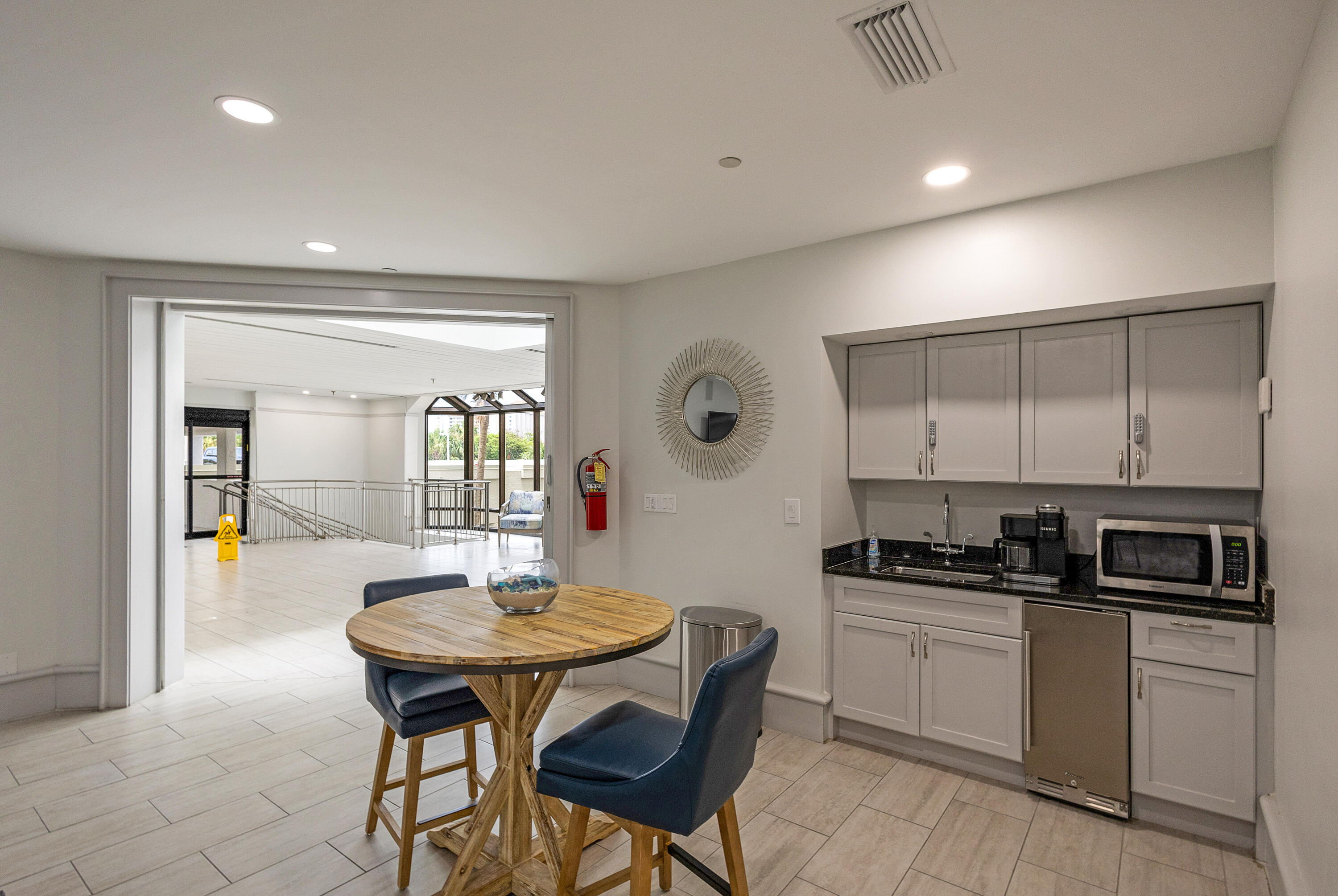 4299 Beachside 2, Unit 4299 Miramar Beach, FL 32550 - Photo 22 of 43 a kitchen with stainless steel appliances kitchen island a table and chairs in it