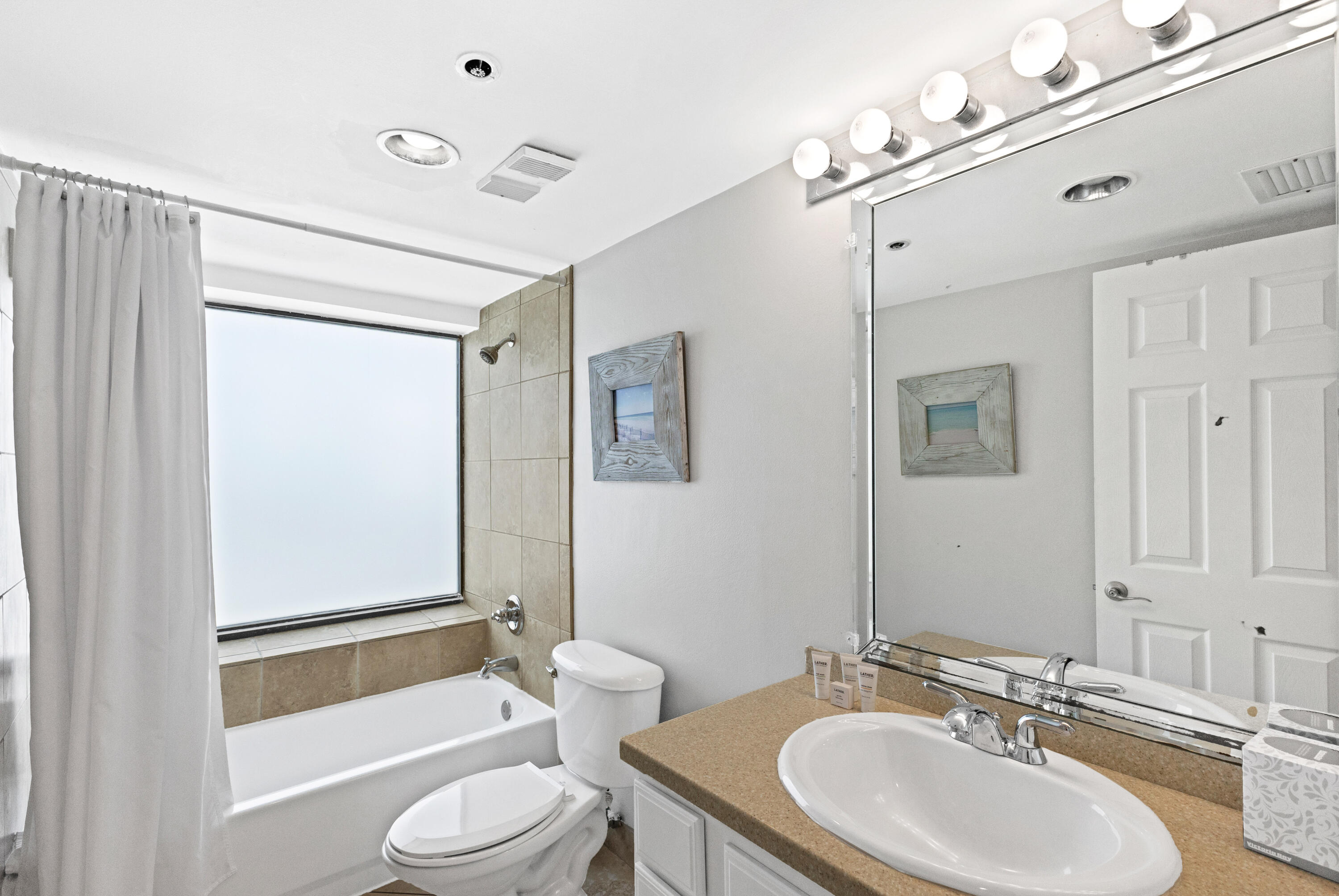 4299 Beachside 2, Unit 4299 Miramar Beach, FL 32550 - Photo 10 of 43 a bathroom with a toilet a sink a mirror a bathtub and shower