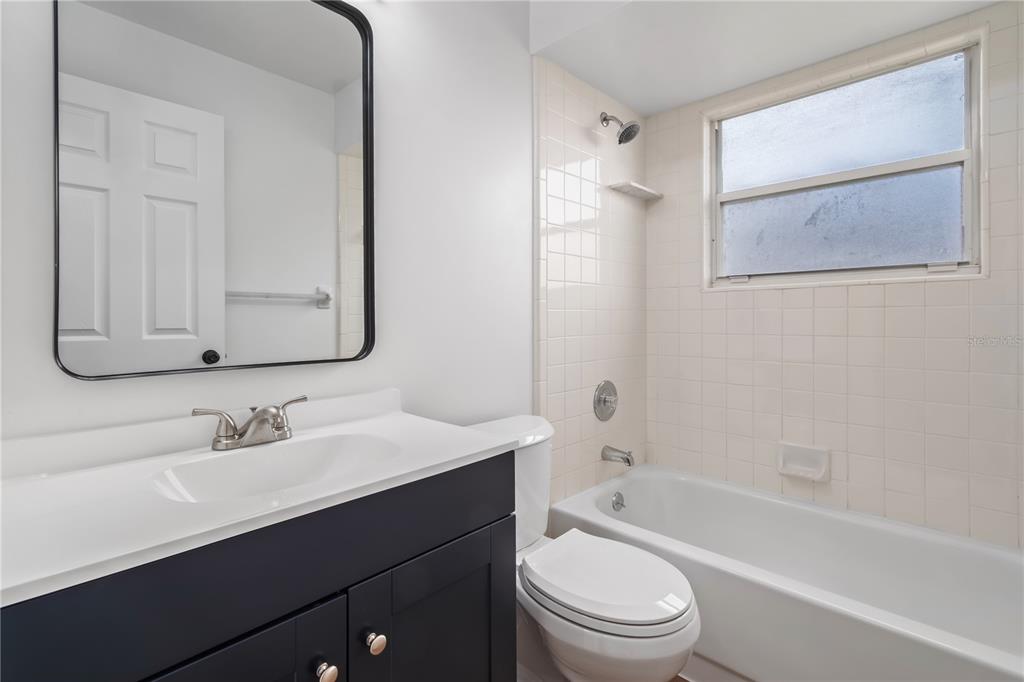 7670 Southwest 80th Place Ocala, FL 34476 - Photo 25 of 44 a bathroom with a bathtub shower sink vanity mirror and toilet