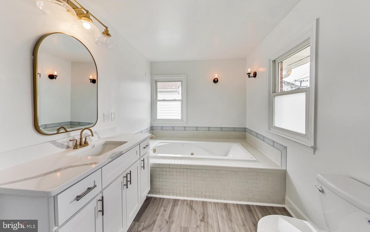 5923 Berwyn Road College Park, MD 20740 - Photo 19 of 51 a bathroom with a tub sink and mirror
