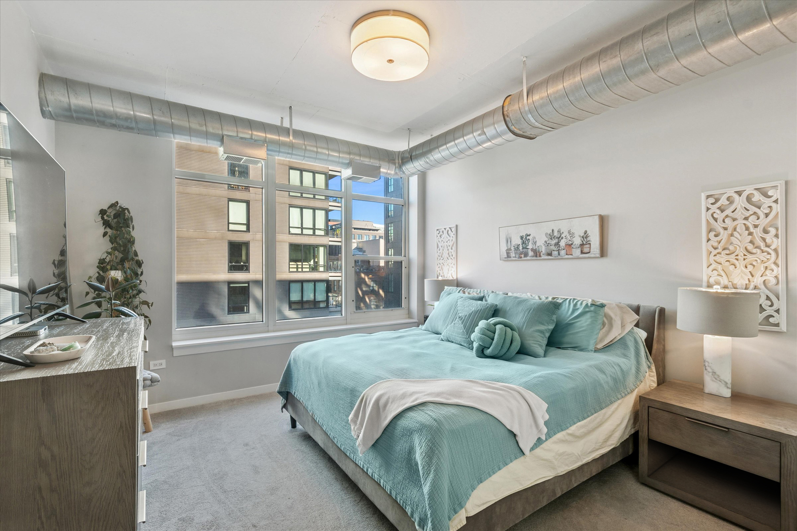 909 West Washington Boulevard, Unit 508 Chicago, IL 60607 - Photo 11 of 20 a bedroom with a bed painting on wall and a large window