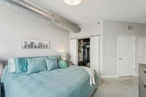 a bedroom with a bed and a chandelier