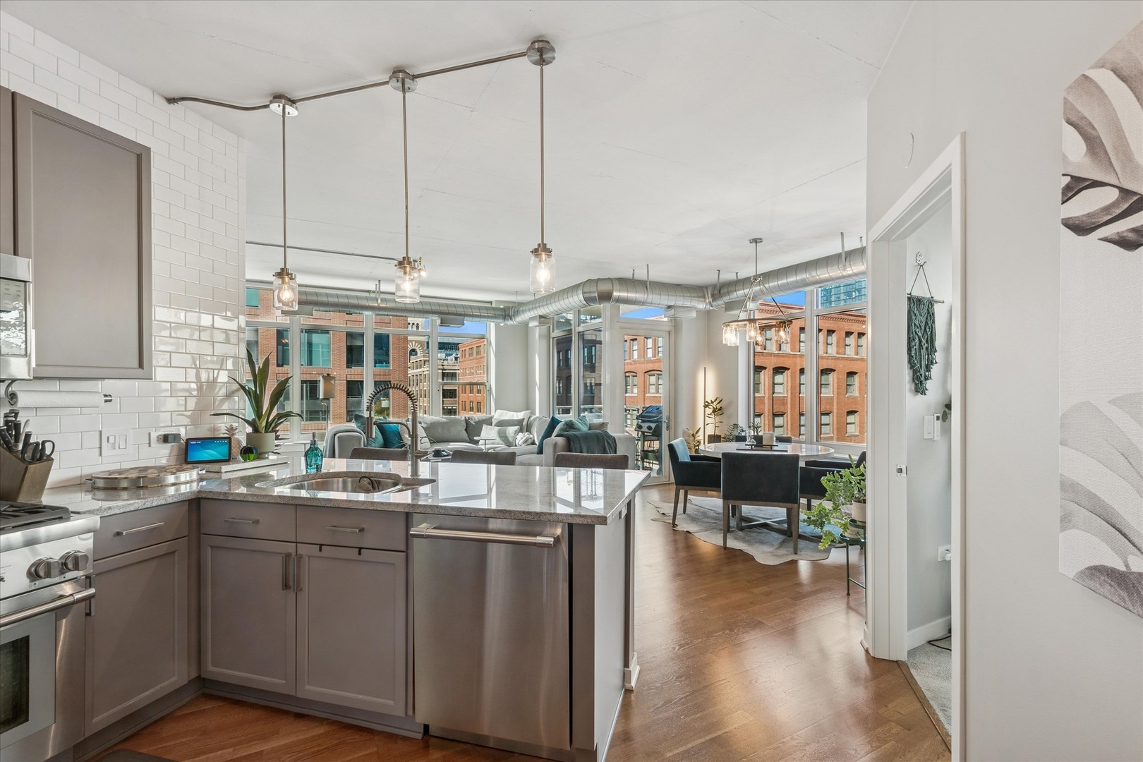 909 West Washington Boulevard, Unit 508 Chicago, IL 60607 - Photo 7 of 20 a kitchen with sink cabinets and wooden floor