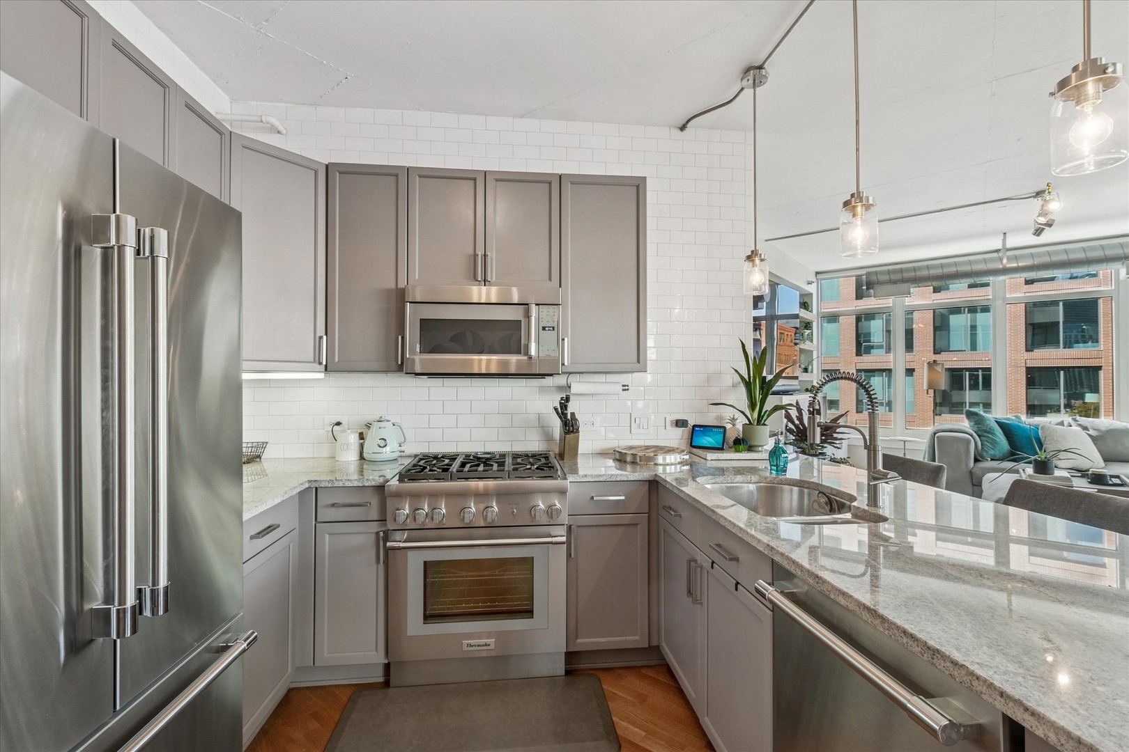 909 West Washington Boulevard, Unit 508 Chicago, IL 60607 - Photo 8 of 20 a kitchen with stainless steel appliances granite countertop a sink stove and refrigerator