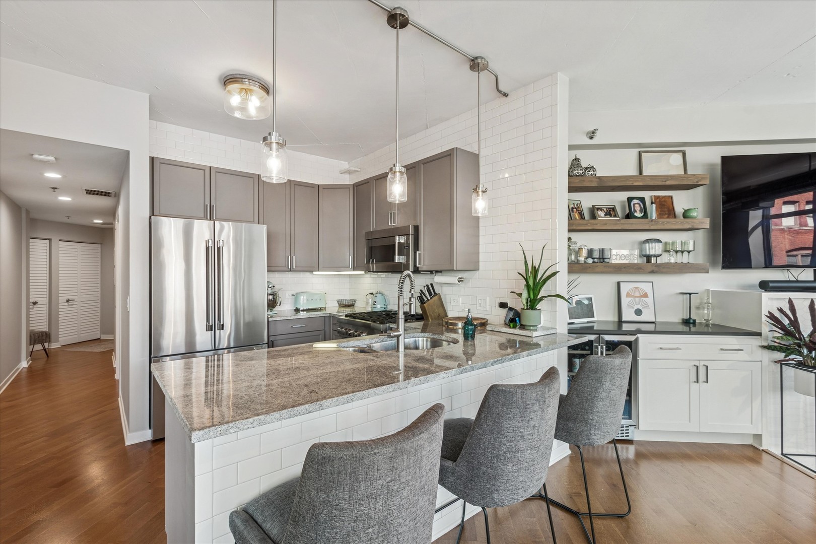 909 West Washington Boulevard, Unit 508 Chicago, IL 60607 - Photo 9 of 20 a kitchen with stainless steel appliances kitchen island granite countertop a sink and cabinets