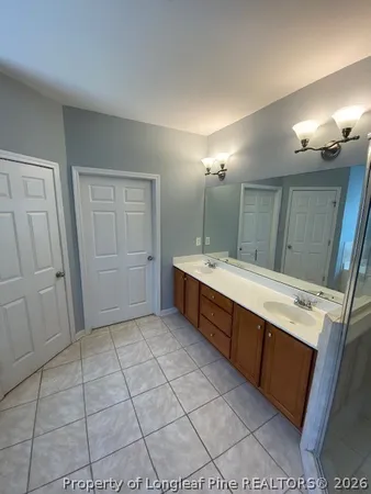 a bathroom with a sink double vanity and a mirror