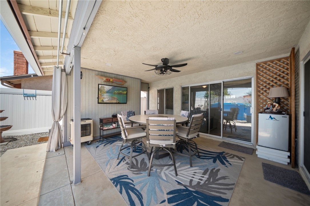 27879 Foxfire Street Menifee, CA 92586 - Photo 31 of 36 a living room with furniture a flat screen tv and large window