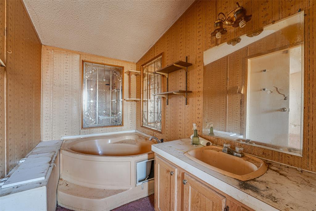 100 Zodiac Strait Road Ferris, TX 75125 - Photo 11 of 19 a bathroom with a sink a bathtub and shower