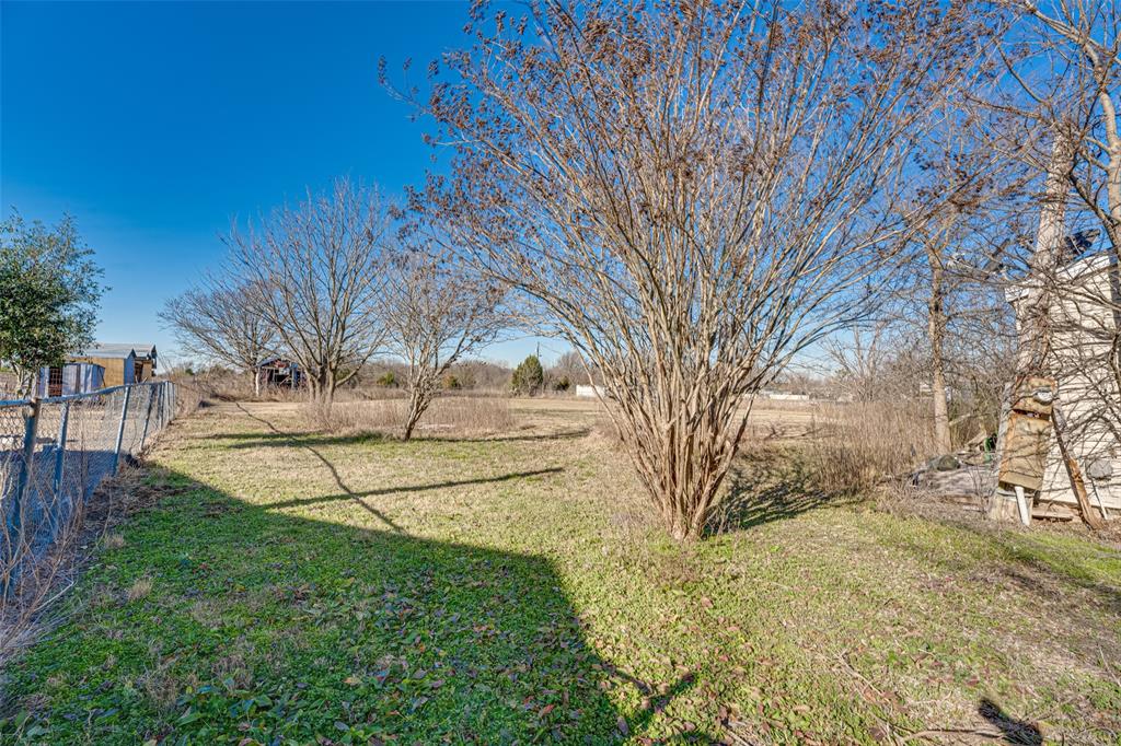 100 Zodiac Strait Road Ferris, TX 75125 - Photo 17 of 19 a view of yard with tree