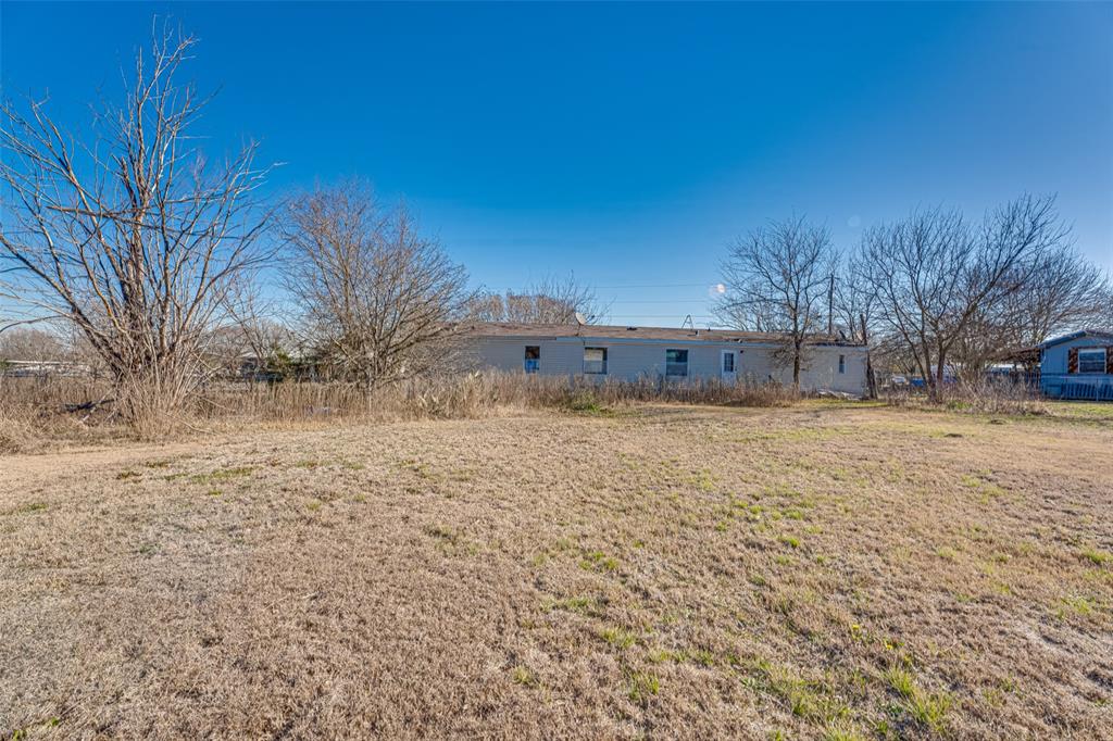 100 Zodiac Strait Road Ferris, TX 75125 - Photo 18 of 19 a view of a yard with a house