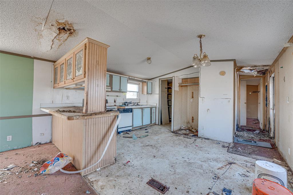 100 Zodiac Strait Road Ferris, TX 75125 - Photo 6 of 19 a kitchen with stainless steel appliances granite countertop a sink and cabinets