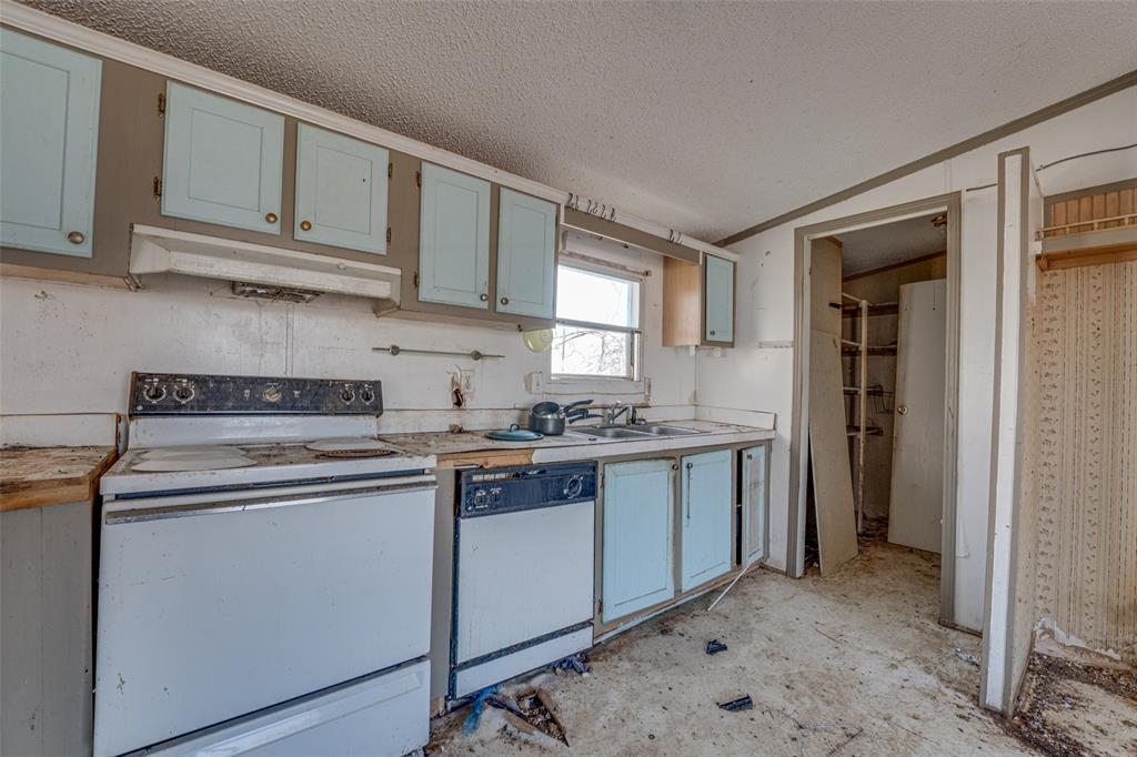 100 Zodiac Strait Road Ferris, TX 75125 - Photo 7 of 19 a kitchen with stainless steel appliances granite countertop a sink and cabinets