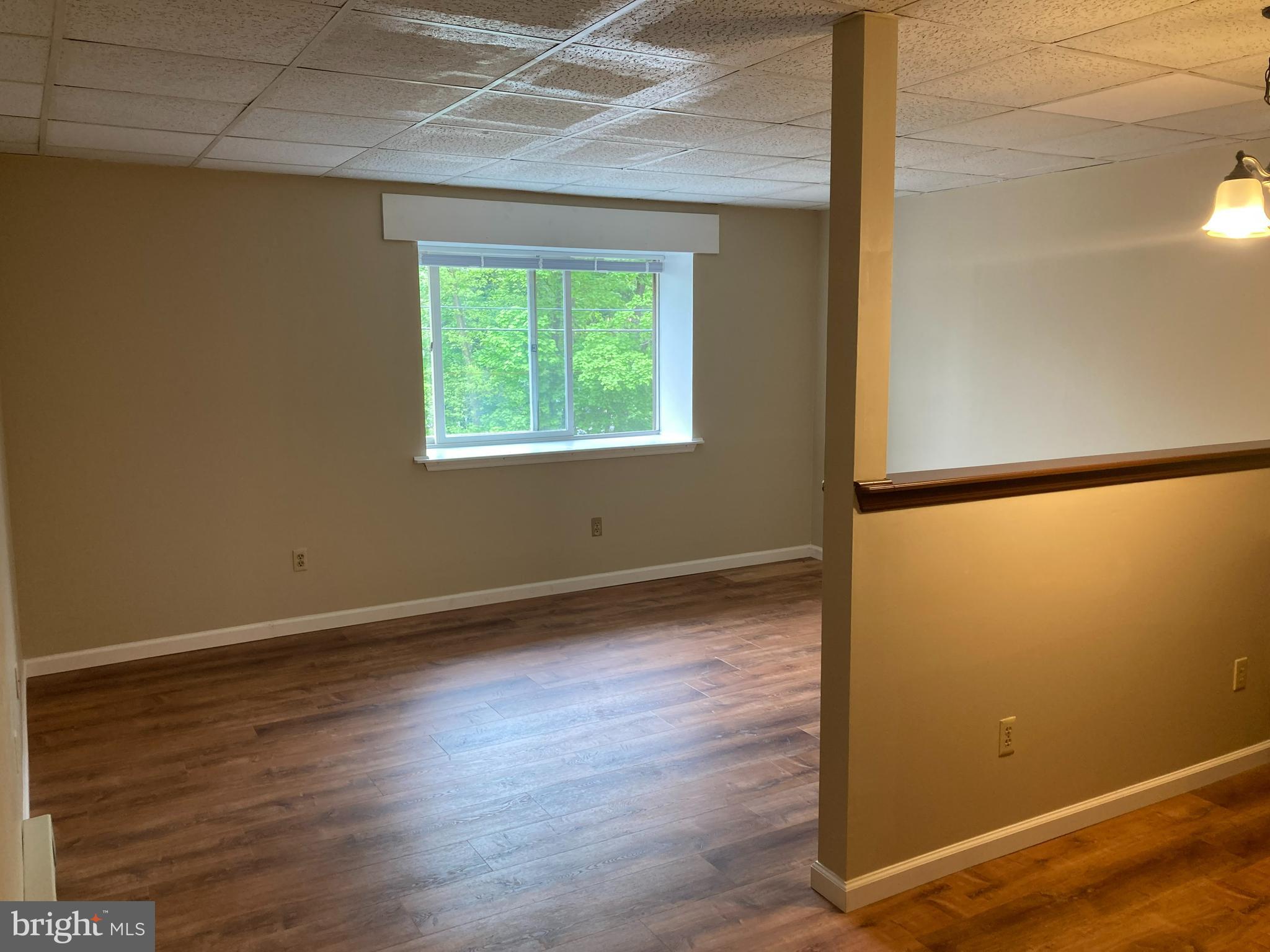 102 Delaware Road, Unit 2 Riegelsville, PA 18077 - Photo 2 of 9 an empty room with wooden floor and windows
