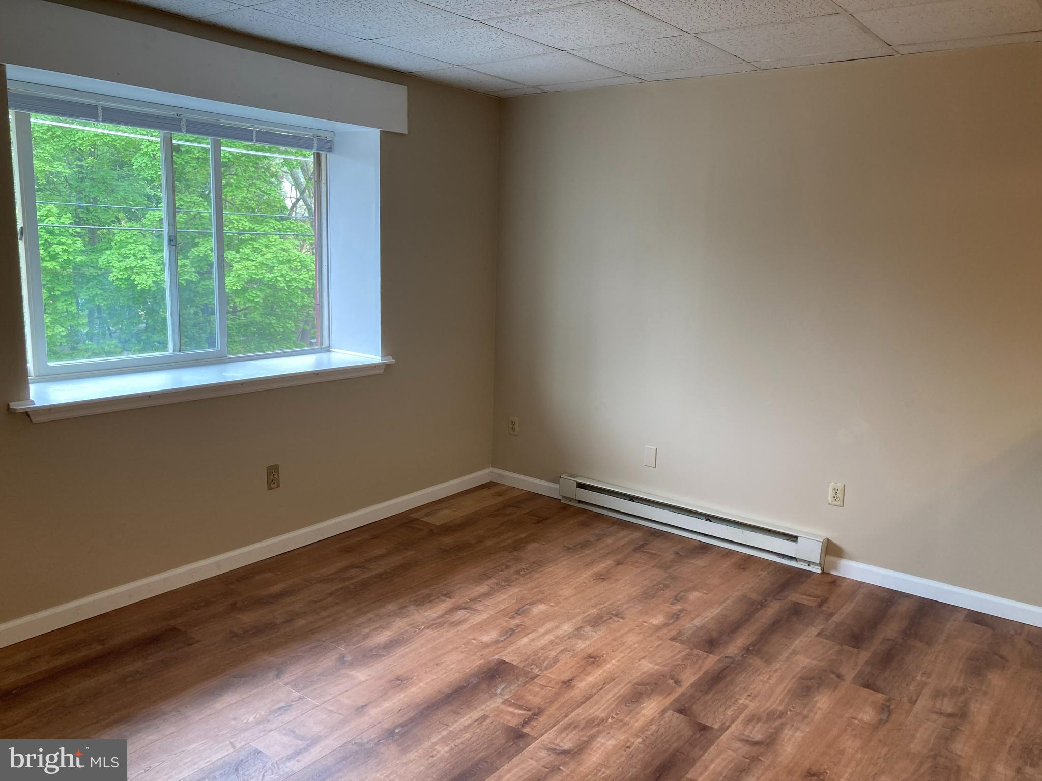 102 Delaware Road, Unit 2 Riegelsville, PA 18077 - Photo 3 of 9 an empty room with wooden floor and windows