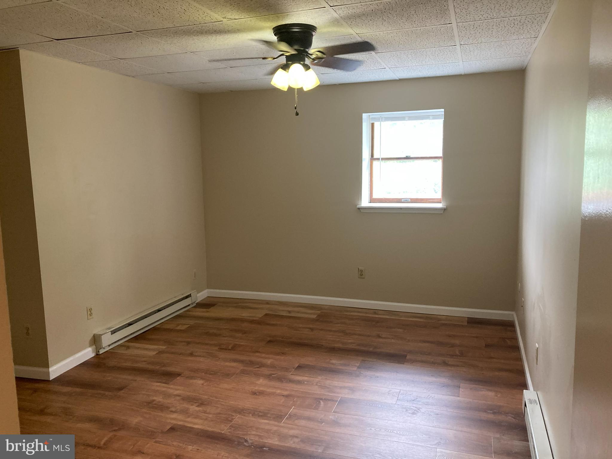 102 Delaware Road, Unit 2 Riegelsville, PA 18077 - Photo 7 of 9 wooden floor in an empty room with a window
