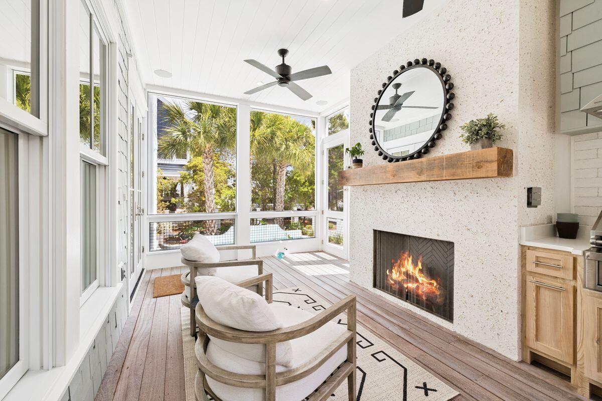 41 North Shingle Lane Watersound, FL 32461 - Photo 11 of 48 a living room with furniture a fireplace and a floor to ceiling window