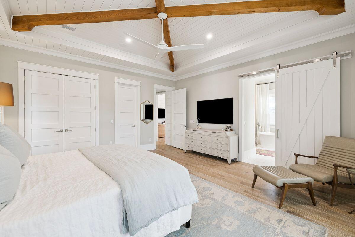 41 North Shingle Lane Watersound, FL 32461 - Photo 20 of 48 a bedroom with a bed and a flat screen tv